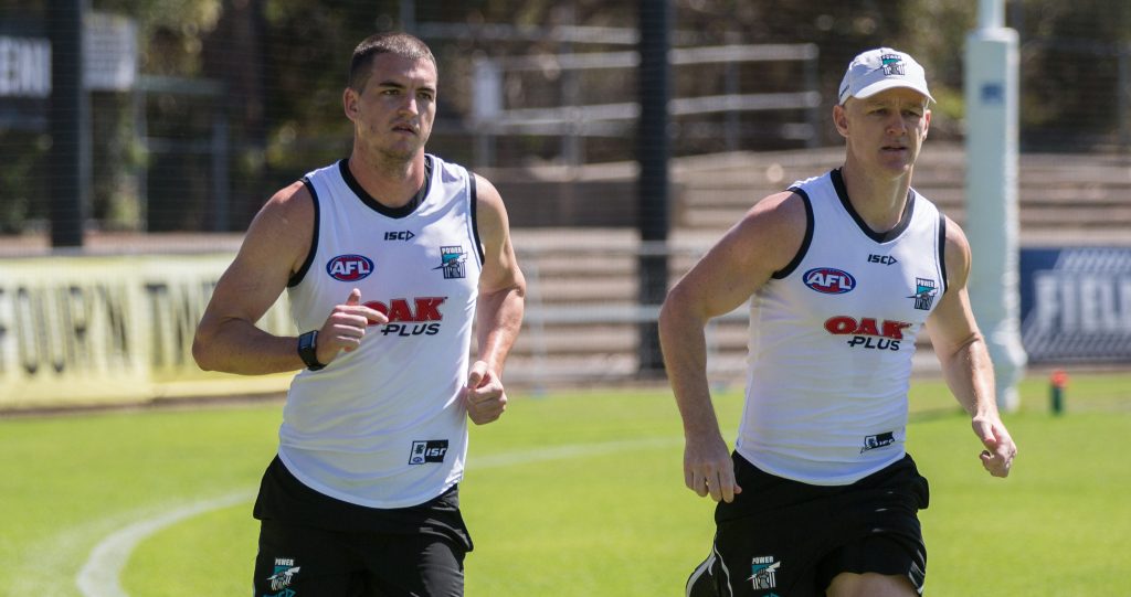 ROCK N' ROBBIE: New Power recruit Tom Rockliff and veteran Robbie Gray on the training track yesterday. Photo: Ben Macmahon / AAP