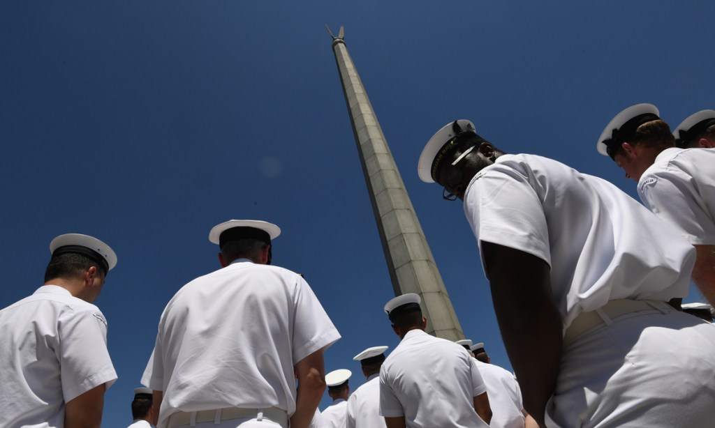 Naval officers listen to PM Malcolm Turnbull during the announcement of the winning bid to build the Offshore Patrol Vessels at the Department of Defence in Canberra. Photo: AAP