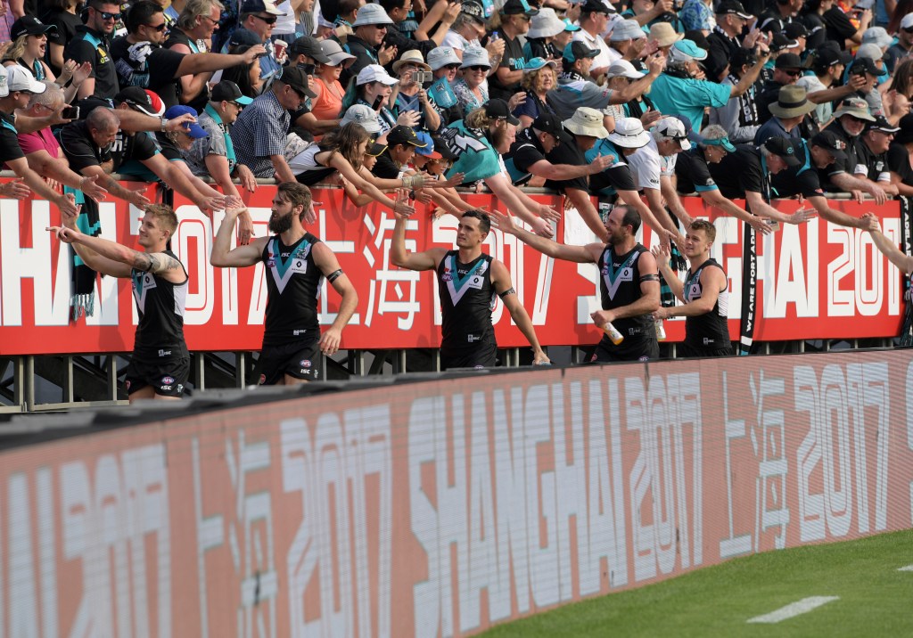 Port players celebrate with fans after their win in Shanghai last year. Photo: AAP/Tracey Nearmy