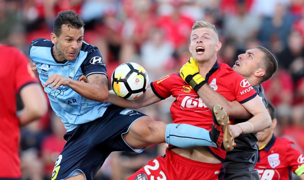 Jordan Elsey, clashing here with Sydney striker Bobo,   is among the A-League’s most in-form defenders. Photo: AAP/James Elsby