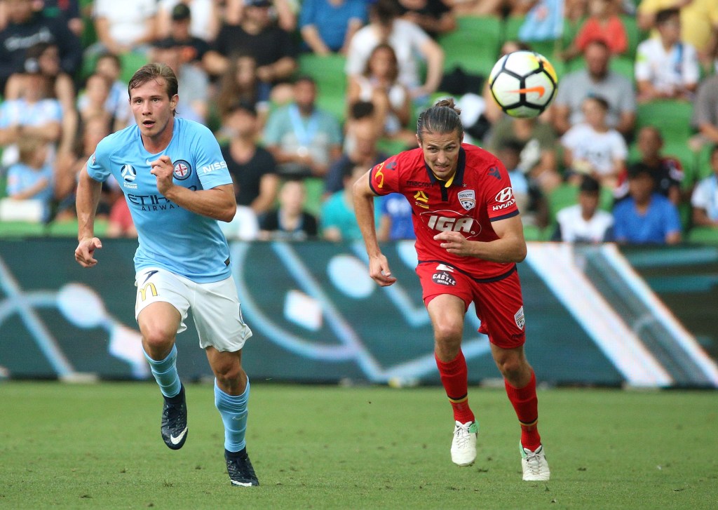 United's Michael Marrone (right) under pressure from Melbourne City's Nick Fitzgerald. Photo: AAP/Hamish Blair