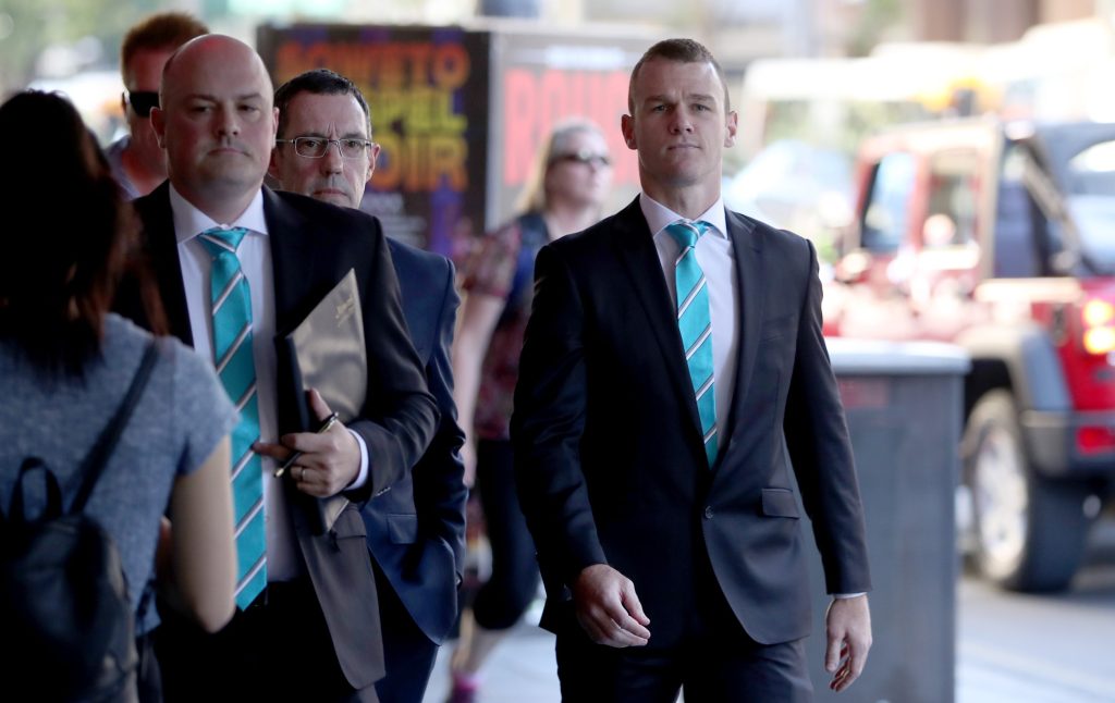 Robbie Gray (right) arrives for his AFL Tribunal hearing in Adelaide yesterday. Photo: AAP/Kelly Barnes