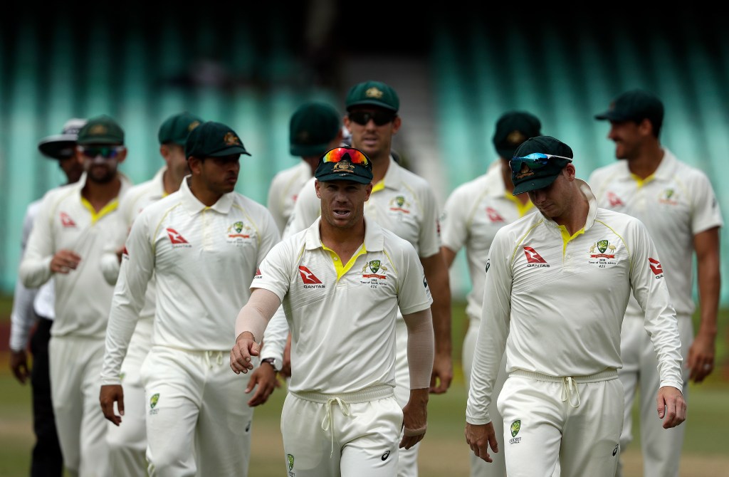 David Warner, centre, leaves the field in Durban surrounded by his teammates. Photo: AP Photo/Themba Hadebe