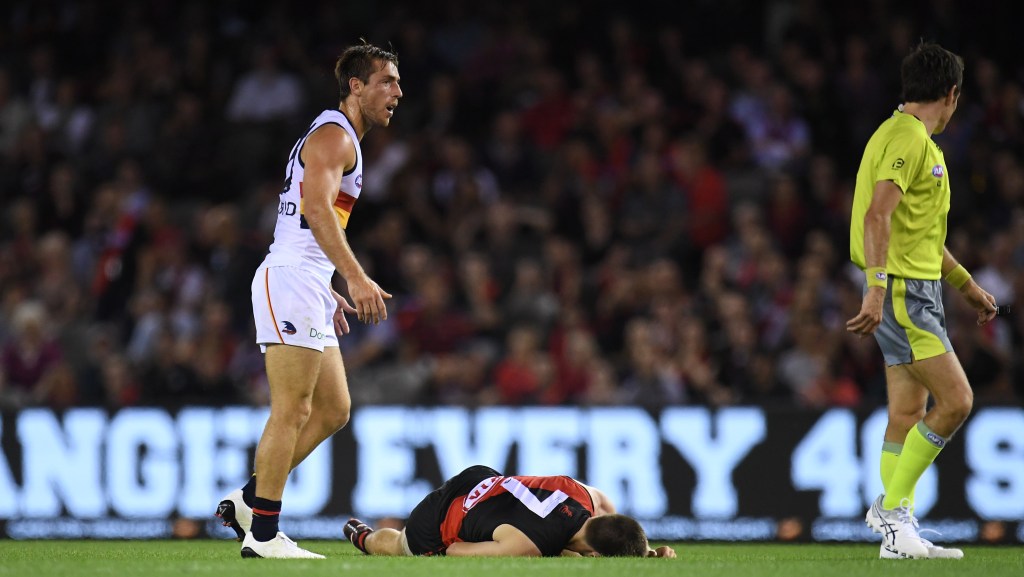 Richard Douglas stands over Zach Merrett after they clashed on Friday. Photo: AAP/Julian Smith
