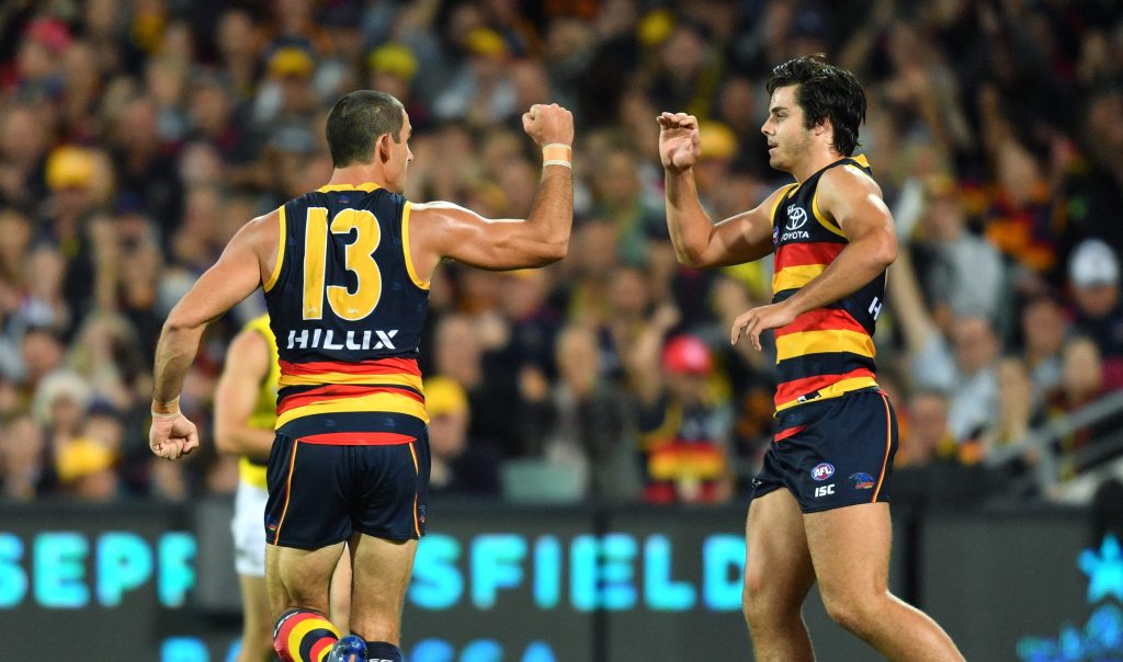 Youngster Darcy Fogarty (right) with the man he replaces in tonight's team - injured skipper Taylor Walker. Photo: AAP/David Mariuz