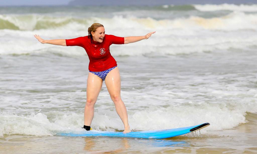 A woman learning to surf at Rainbow Beach near Noosa. Photo: Supplied