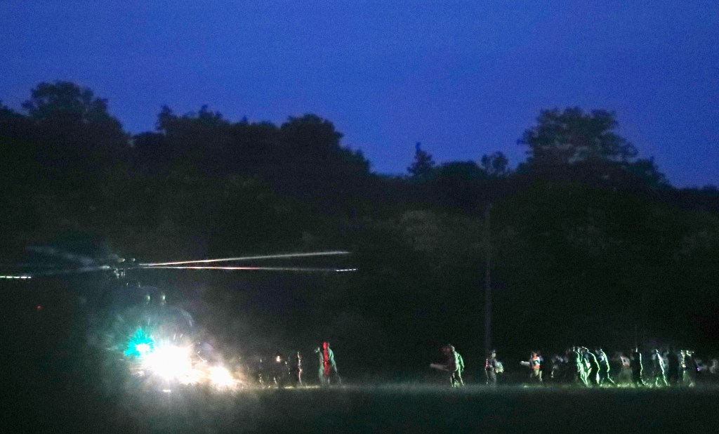 Thai medics and police officers evacuate the first two children with a helicopter. Photo: EPA/Rungroj Yongrit