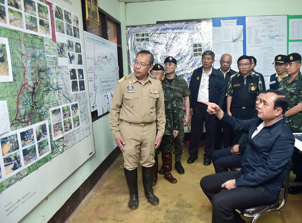 Thai Prime Minister Prayut Chan-o-cha (right) being briefed about the rescue operation. Photo: EPA/Supplied by Thai Government