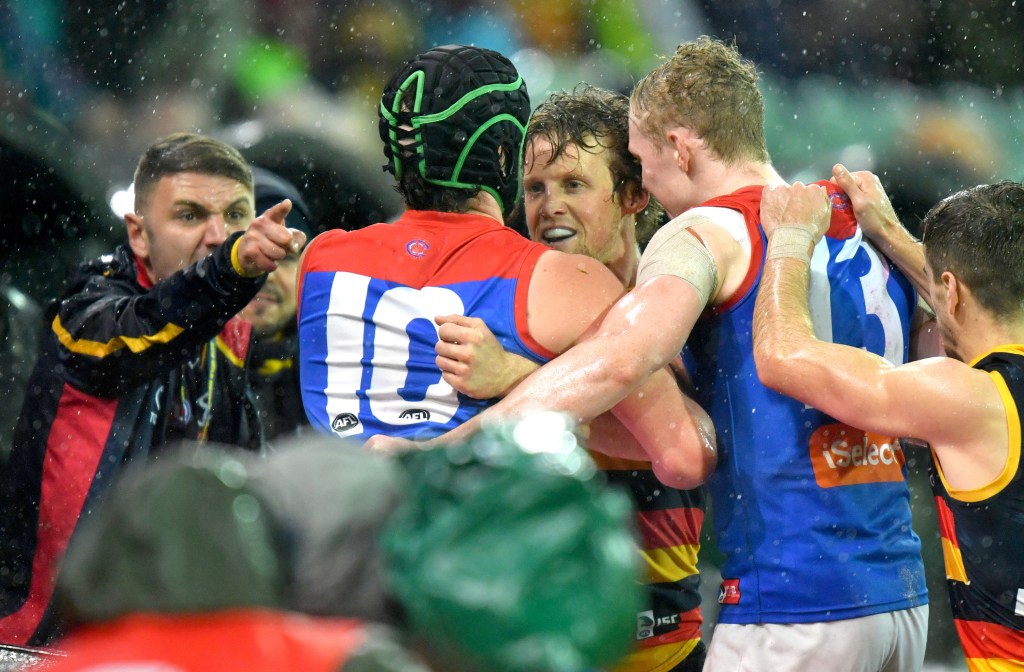 A supporter playing 'eenie meenie miney mo' correctly identifies the winner of Saturday's game. Photo: Sam Wundke / AAP