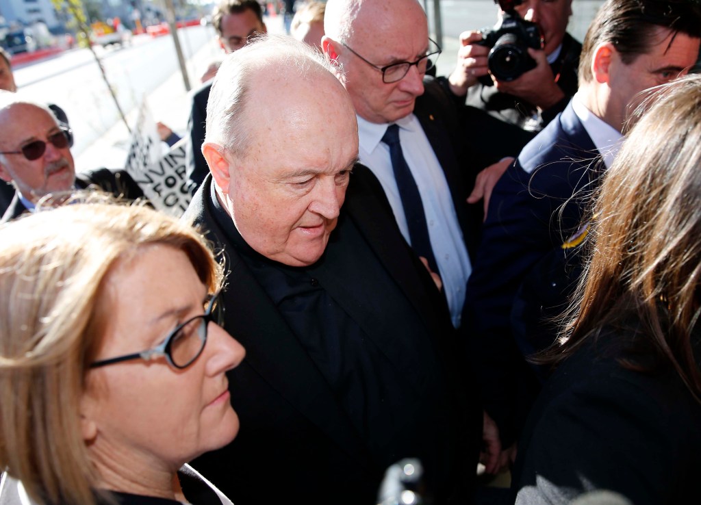 Former Adelaide Archbishop Philip Wilson (centre)
arrives at Newcastle Local Court today. Photo: AAP/Darren Pateman