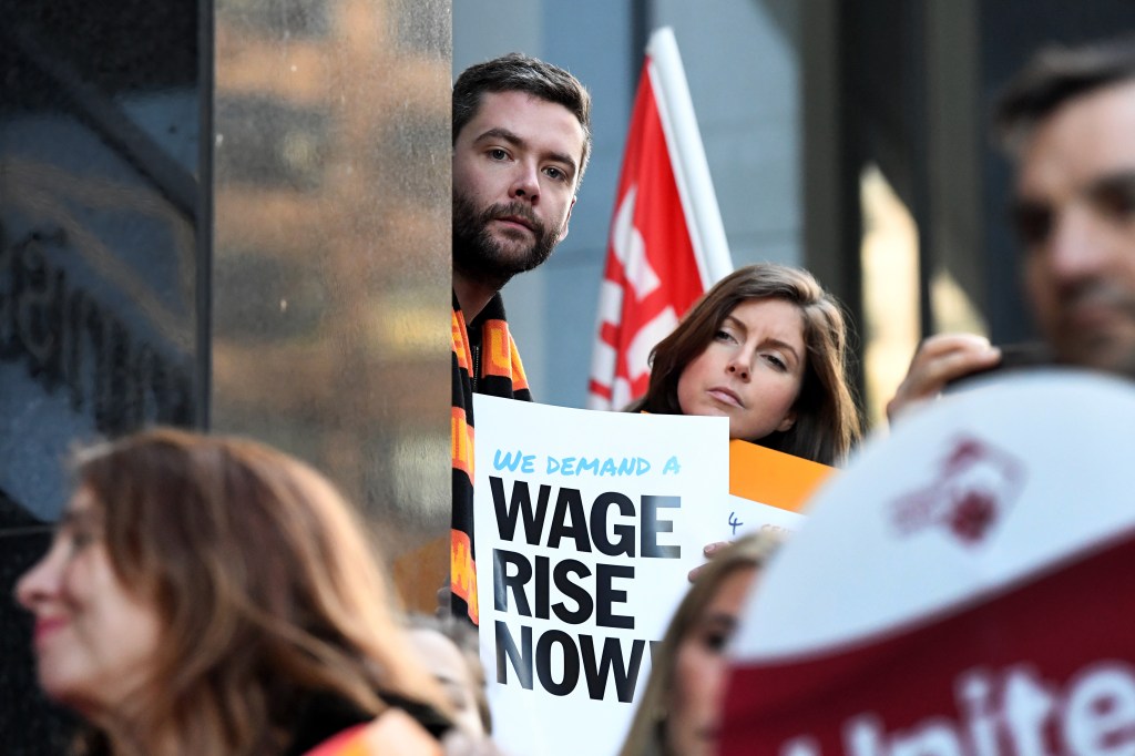 Protesters call for increases in the minimum wage outside the offices of the Fair Work Commission in Melbourne. Photo: AAP/Joe Castro