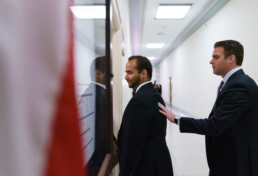 George Papadopoulos, (left) the former Trump campaign adviser who triggered the Russia investigation, is guided as he arrives for his first appearance before congressional investigators on Capitol Hill. Photo: AP/Carolyn Kaster