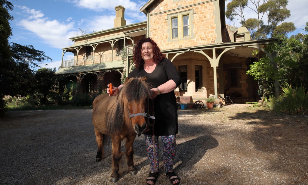 Kay Haines with resident pony Harry at Coreega in Springfield. Photo: Tony Lewis / InDaily