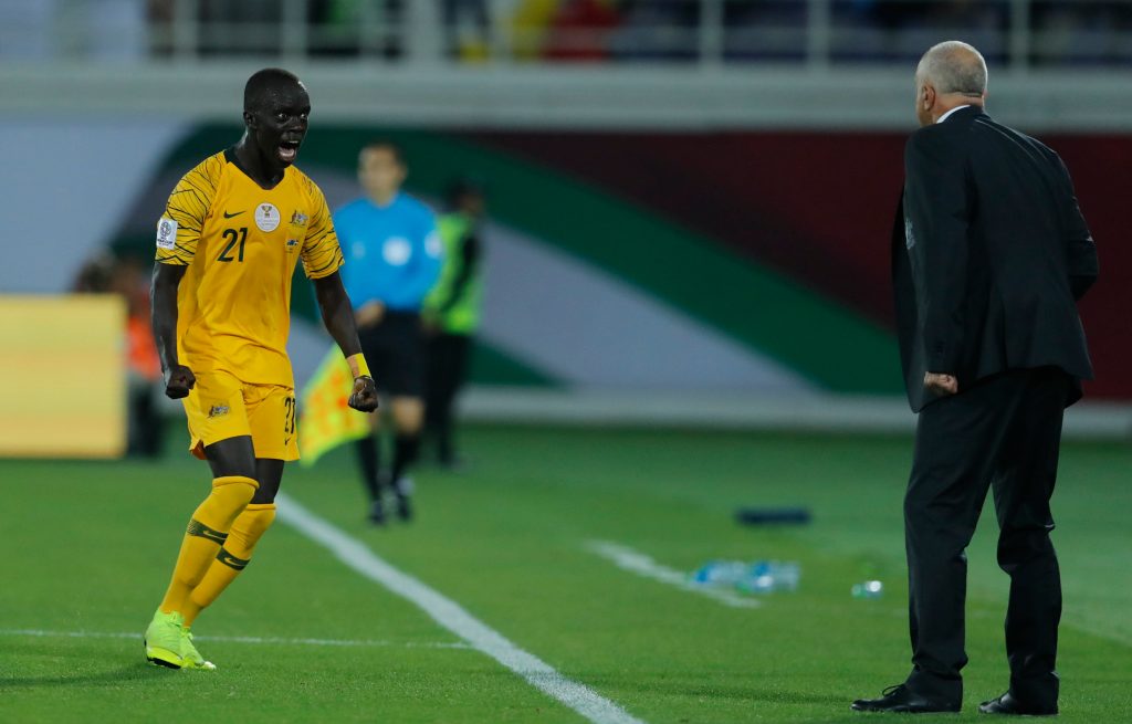 Awer Mabil celebrates with Graham Arnold after scoring against Syria. Photo: AP/Hassan Ammar