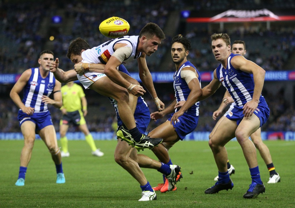 Lachie Murphy is crunched by Scott Thompson (the one who plays for the Kangaroos, not the good one). Photo: Hamish Blair / AAP