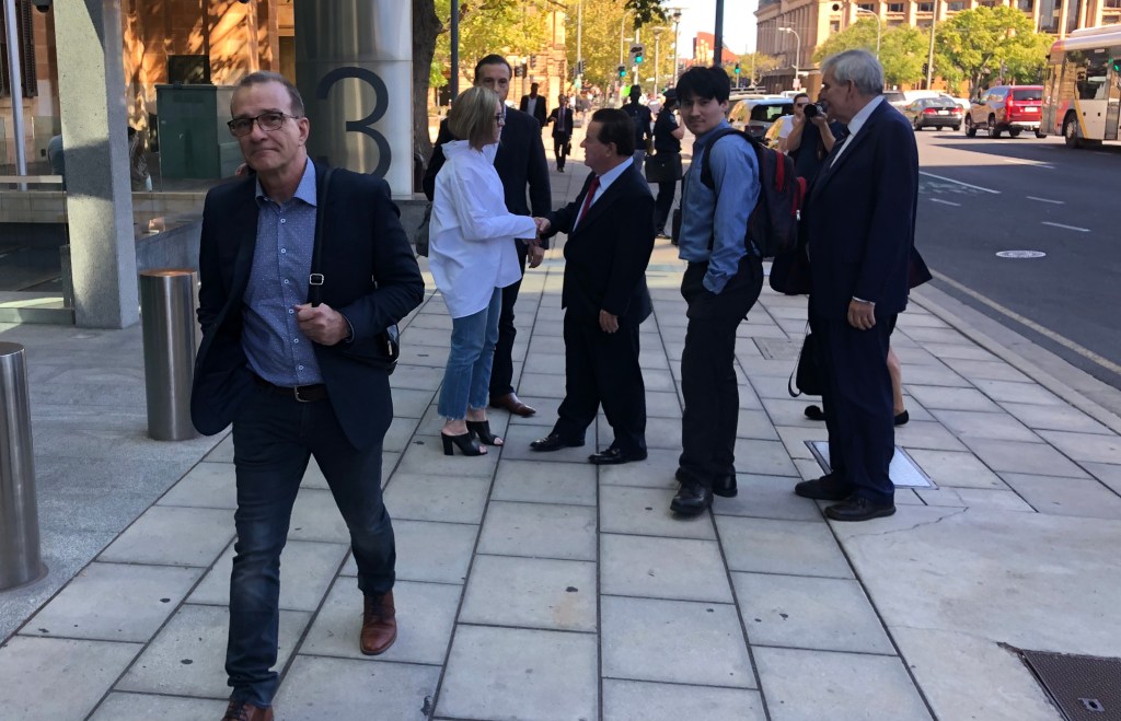 Henry Keogh leaves court today, with supporters in the background. Photo: Tom Richardson / InDaily