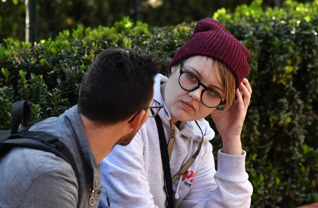 A woman who attempted to egg Prime Minister Scott Morrison is spoken to. Photo: AAP/Mick Tsikas