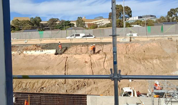 Workers spraying the 'shotcrete' facade on the section of roadway. Photo: via CFMEU