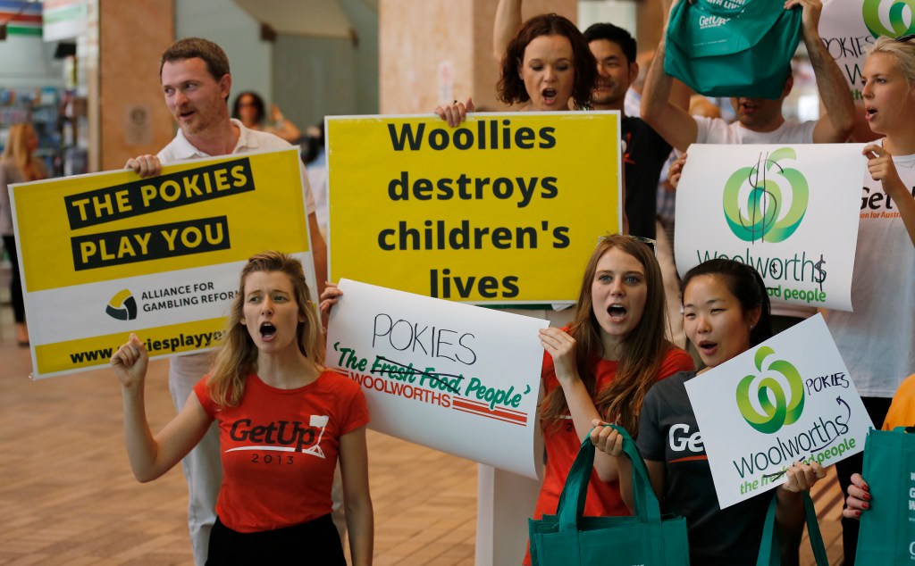 Anti-pokies protestors outside a Woolworths AGM in 2015. Photo: AAP/David Moir