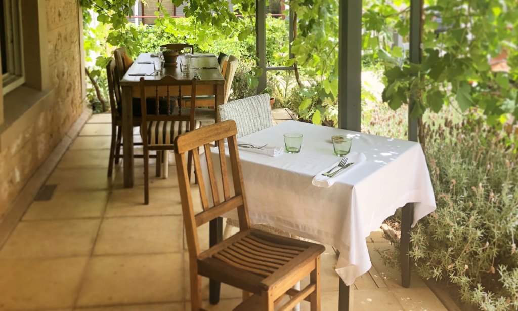 The vine-covered verandah of The Olfactory Inn.
