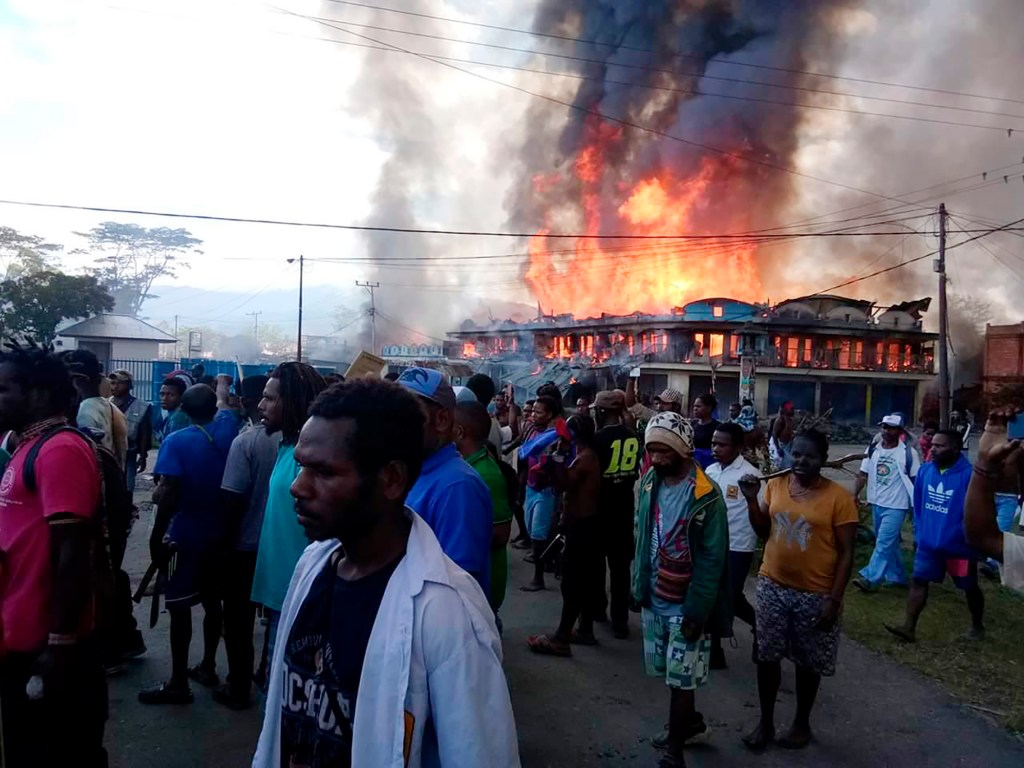 Buildings burn during a protest in Indonesia's Papua province. Photo: AP