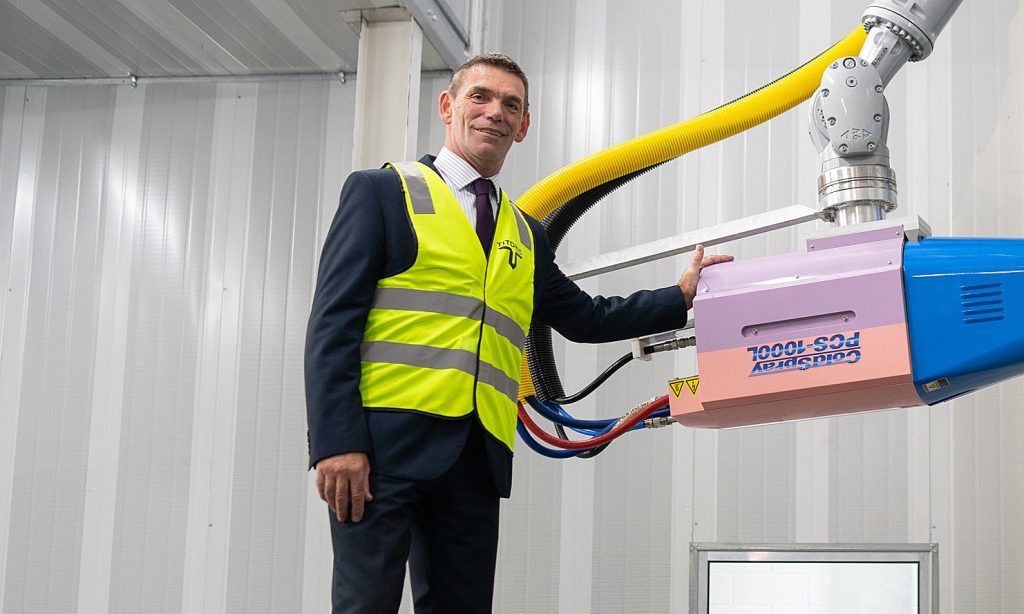 Titomic CEO Jeff Lang with the world's largest metal 3D printer, which the firm used to make a titanium rocket. Photo: AAP/Titomic