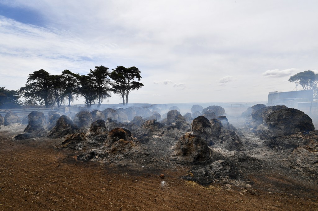 Smoke rises from burning hay bales on Kangaroo Island. Photo: David Mariuz / AAP