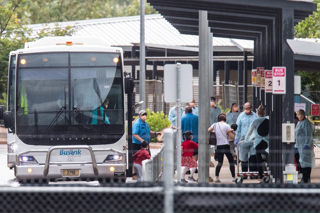 Australian evacuees from  Wuhan arrive at a disused work camp outside Darwin. Photo: AAP/Helen Orr