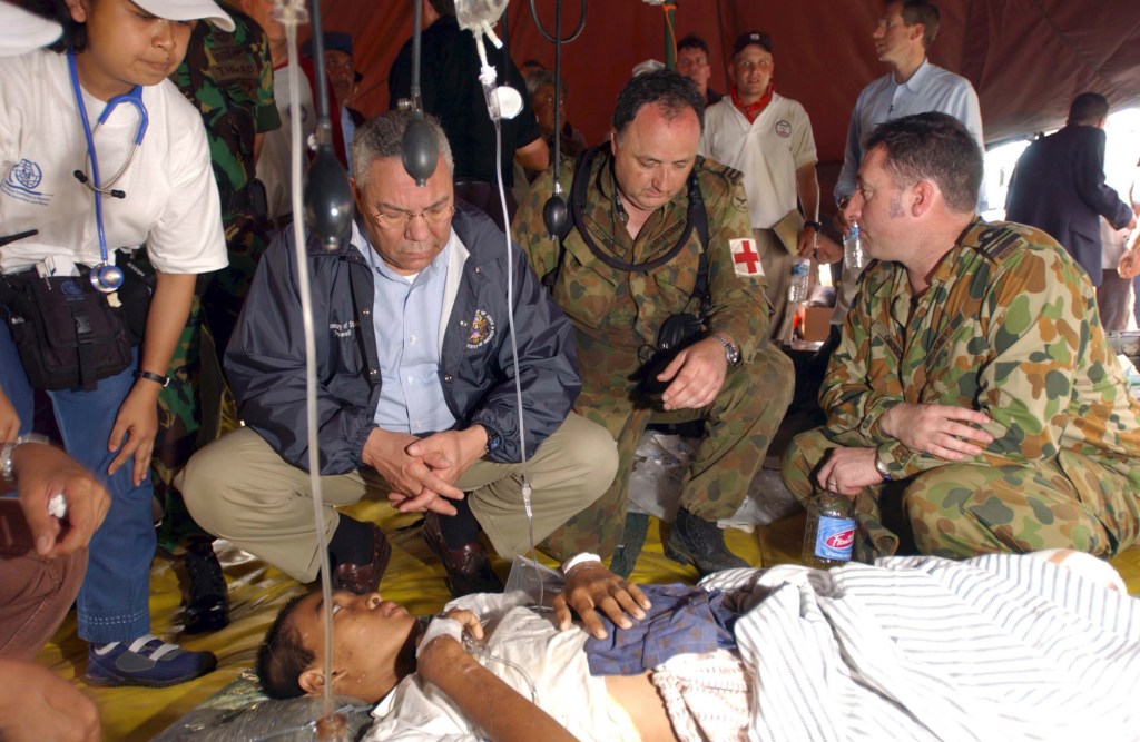 Dr Bill Griggs with then-US Secretary of State Colin Powell in tsunami-ravaged Banda Aceh in 2005. Photo: AAP