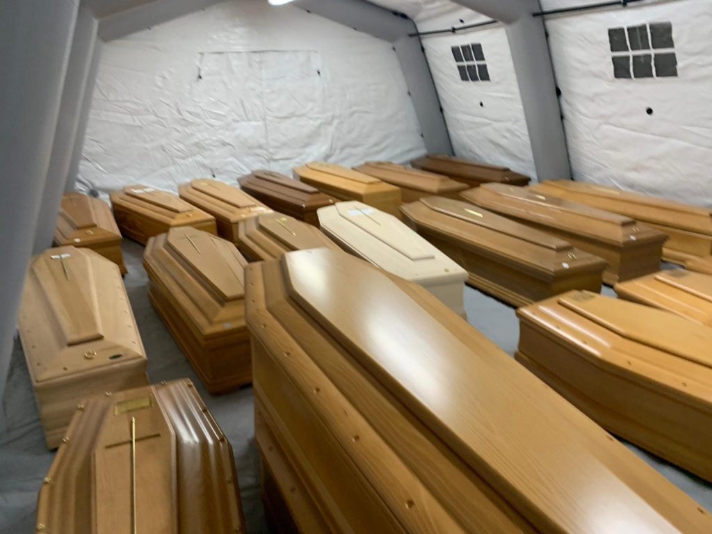 The coffins of the coronavirus dead are piled up in the church of Every Saints in the cemetery in Bergamo, Italy. Photo: EPA/Tiziano Manzoni
