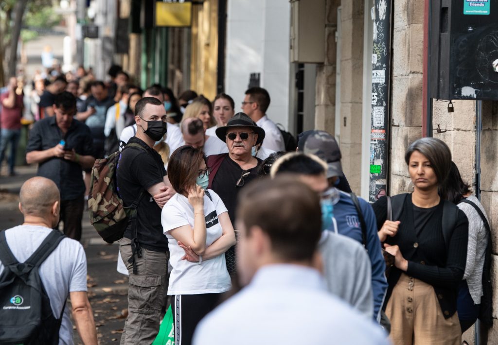 People queue outside Centrelink after the first pandemic restrictions hit last year. Photo: AAP/James Gourley