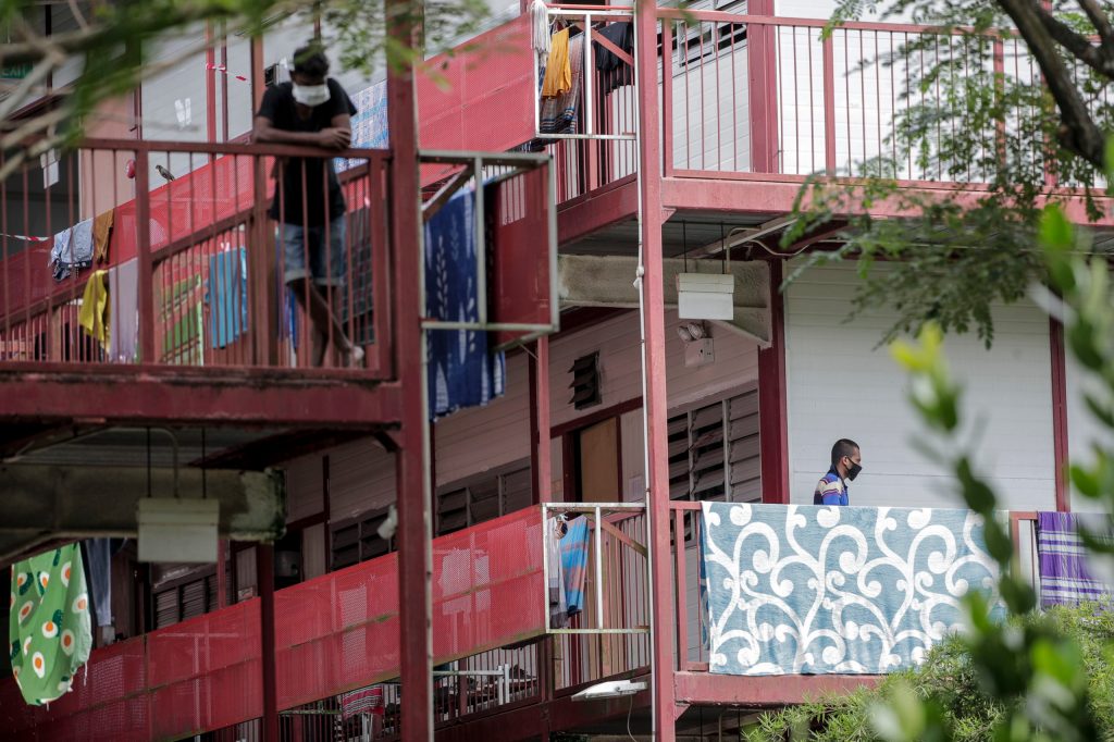 Migrant workers wearing protective masks at a foreign worker dormitory in Singapore. Photo: EPA/Wallace Woon