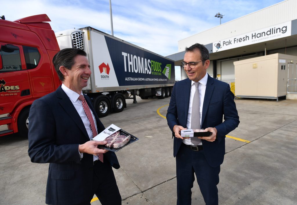 Trade minister Simon Birmingham and Premier Steven Marshall wave off a flight of SA food exports to Asia. Photo: AAP/David Mariuz 
