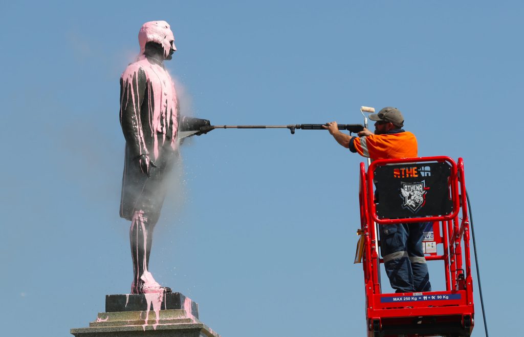 A Captain Cook statue is cleaned after being targeted in Melbourne. Photo: AAP/David Crosling