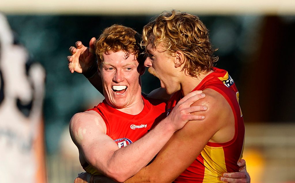 One of Fumbles' former favourites Hugh Greenwood shares a moment with some guy from Gold Coast named Matthew Rowell, whom the commentators barely mentioned at all during yesterday's game for some reason. Photo: Dave Hunt / AAP