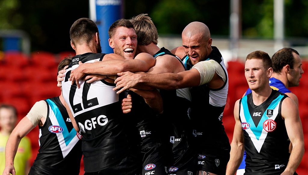 Port Adelaide: ok at football, terrible at social distancing. Photo: Dave Hunt / AAP