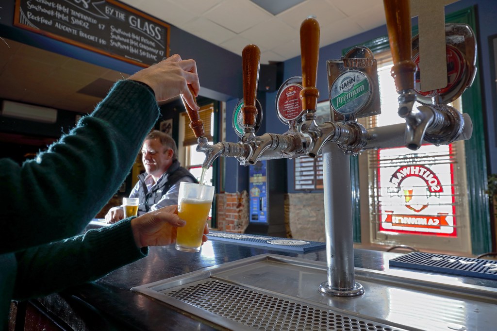 Publican Verity Ferguson pulls a beer at the Southwark Hotel after pubs reopened yesterday. Photo: Tony Lews/InDaily