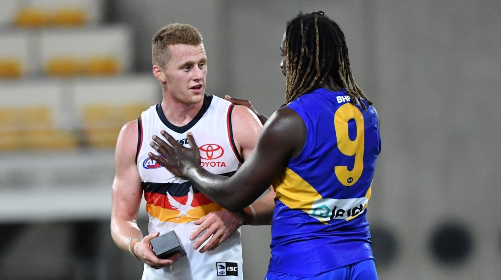 Nic Naitanui shares a moment - and a brand new $1500 phone - with Reilly O'Brien. Photo: Darren England / AAP