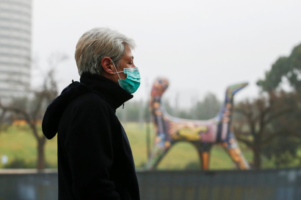 A masked woman walking in Melbourne. Photo: AAP/Daniel Pockett