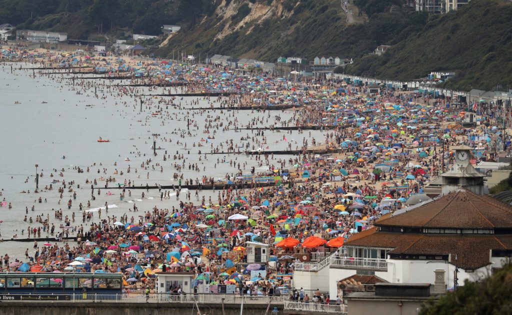 Crowds at Bournemouth in August. Photo: Andrew Matthews/PA via AP