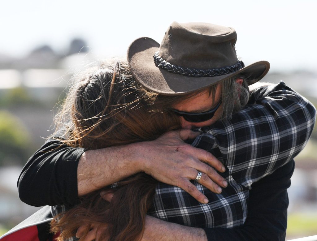 Fisherman Derek Robinson reunites with his family on his to return at Encounter Bay. Photo: David Mariuz / AAP