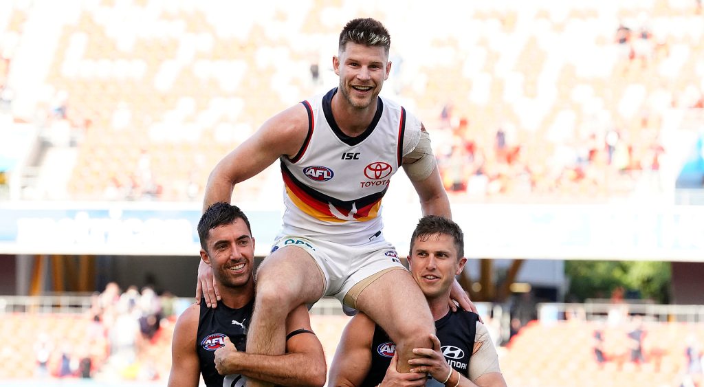 A triumphant Bryce Gibbs is chaired off the ground by two of his team... er, ex-teammates yesterday. Photo: Dave Hunt / AAP