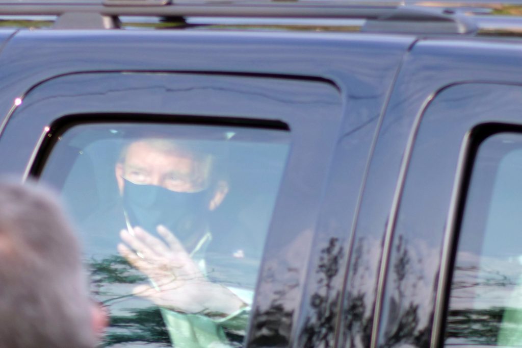 President Donald Trump drives past supporters gathered outside Walter Reed National Military Medical Center in Bethesda, Maryland. Photo: AP/Anthony Peltier