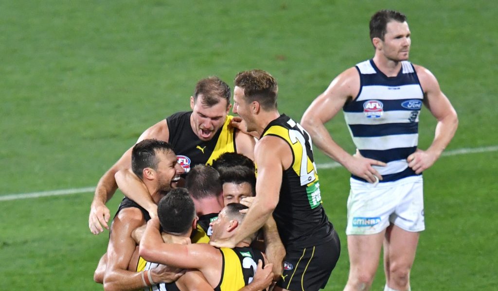 The Tigers celebrate as Paddy fumes. Photo: Darren England / AAP