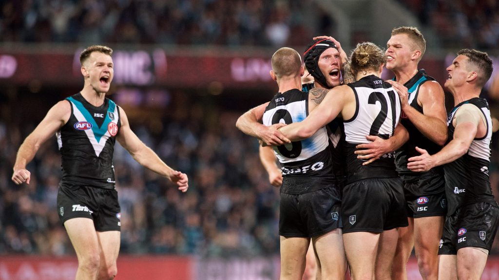 Brad Ebert is mobbed by teammates after kicking a crucial goal on half-time. Photo: MIchael Errey/InDaily