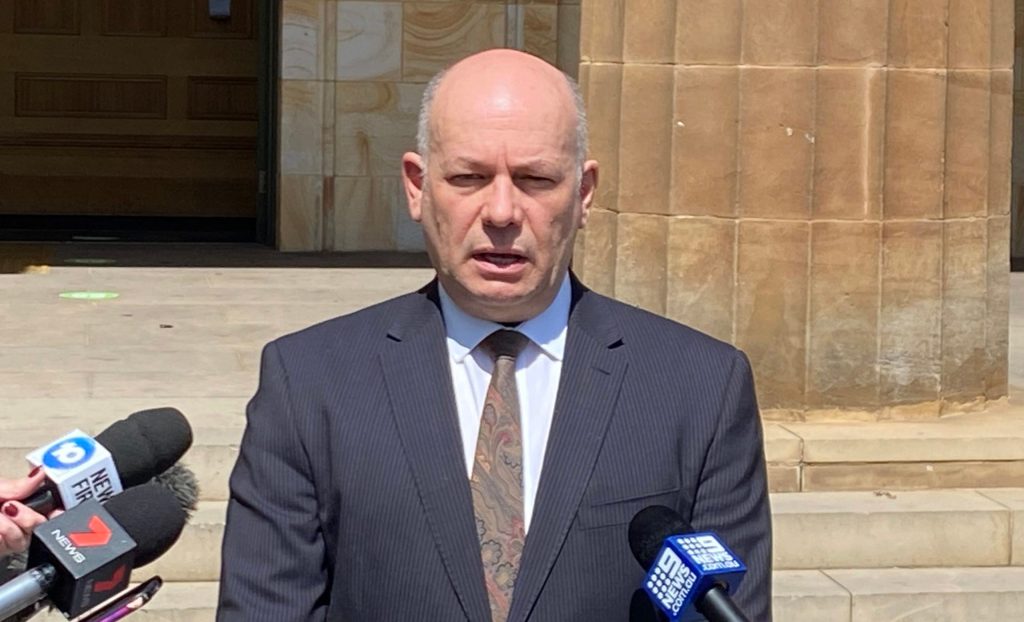 Kris Hanna addresses media outside court.
