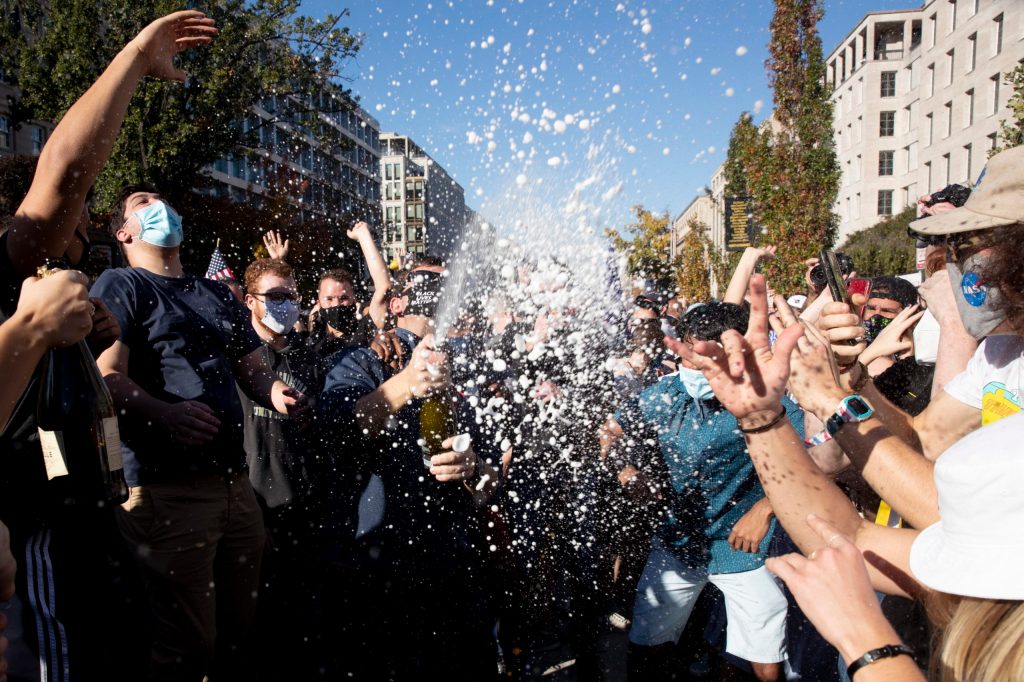 Celebrations erupt on Black Lives Matter plaza near the White House in Washington. Photo: EPA/Michael Reynolds