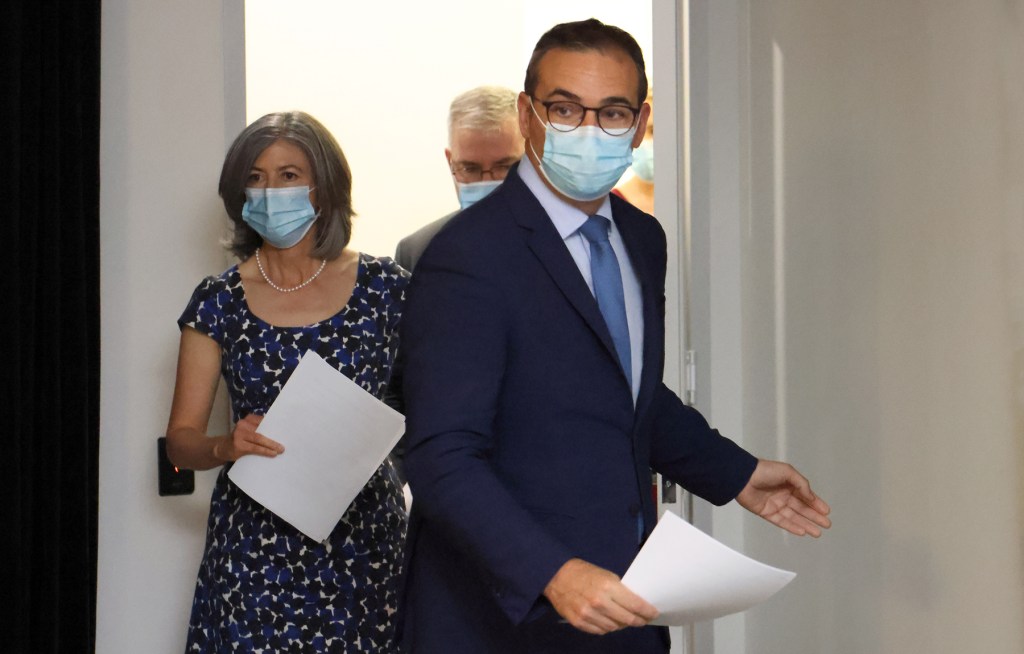 Premier Steven Marshall, chief public health officer Professor Nicola Spurrier and Health Minister Stephen Wade enter yesterday's press conference to announce a six-day lockdown. Photo: Tony Lewis/InDailh