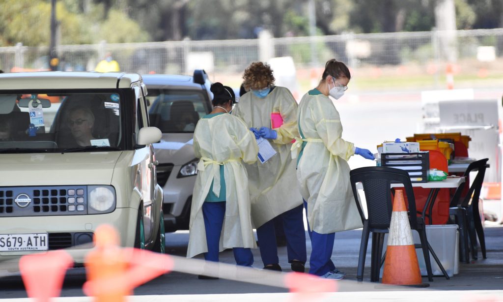 Health workers at the Victoria Park drive-through testing site yesterday. Photo: David Mariuz/AAP