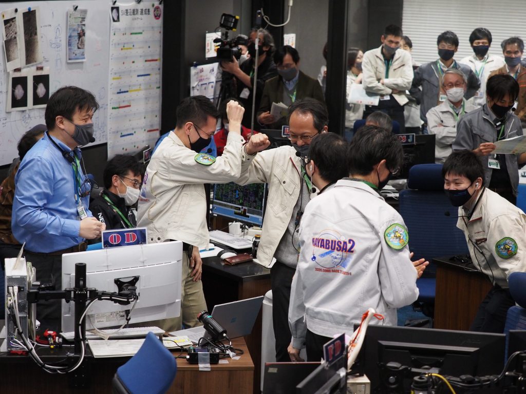 Japan Aerospace Exploration Agency staff celebrate after a capsule successfully separated from the space probe Hayabusa2 before landing near Woomera. Image: EPA/JAXA 
